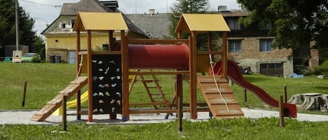 A playground with a slide and climbing structures.
