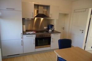 A compact kitchen with a stove, oven, and a coffee maker. - Holiday home in Hammah with swimming pool (Hammah)