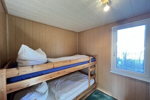 A bunk bed room with wooden walls and a window. - Bungalow holiday paradise (Koserow)