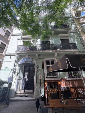 A cafe with outdoor seating, a black awning, and a visible entrance. - Historic 2BRApt. with 2 Bathrooms, Turkish Bath & 3AC @Taksim (Istanbul)