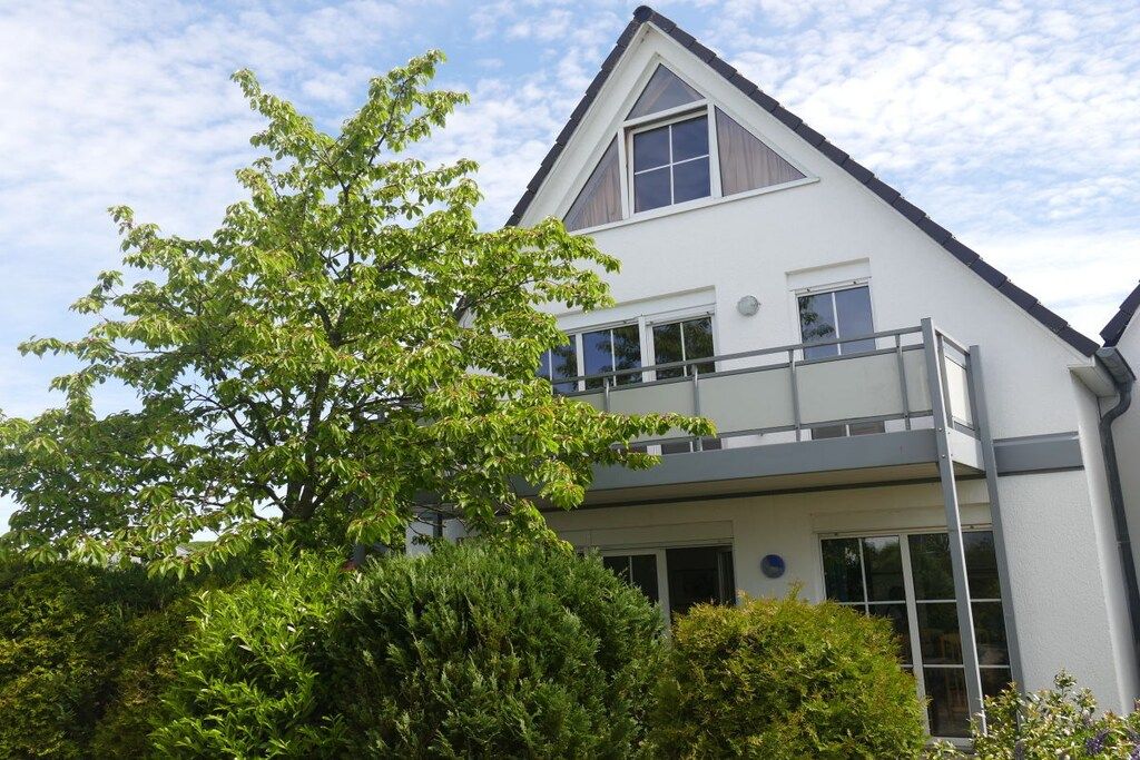 A two-story building with a balcony on the upper floor.