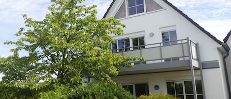 A two-story building with a balcony on the upper floor.