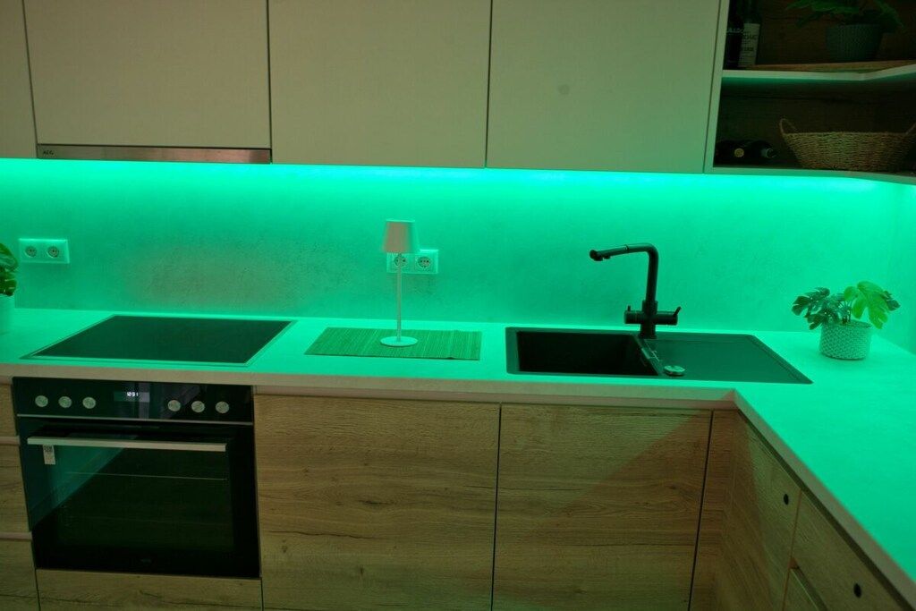 A kitchen with a built-in oven, a sink, and a countertop.
