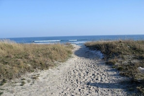 A sandy path leading to the ocean with grassy dunes on either side. - Holiday home in Breege with swimming pool (Breege)