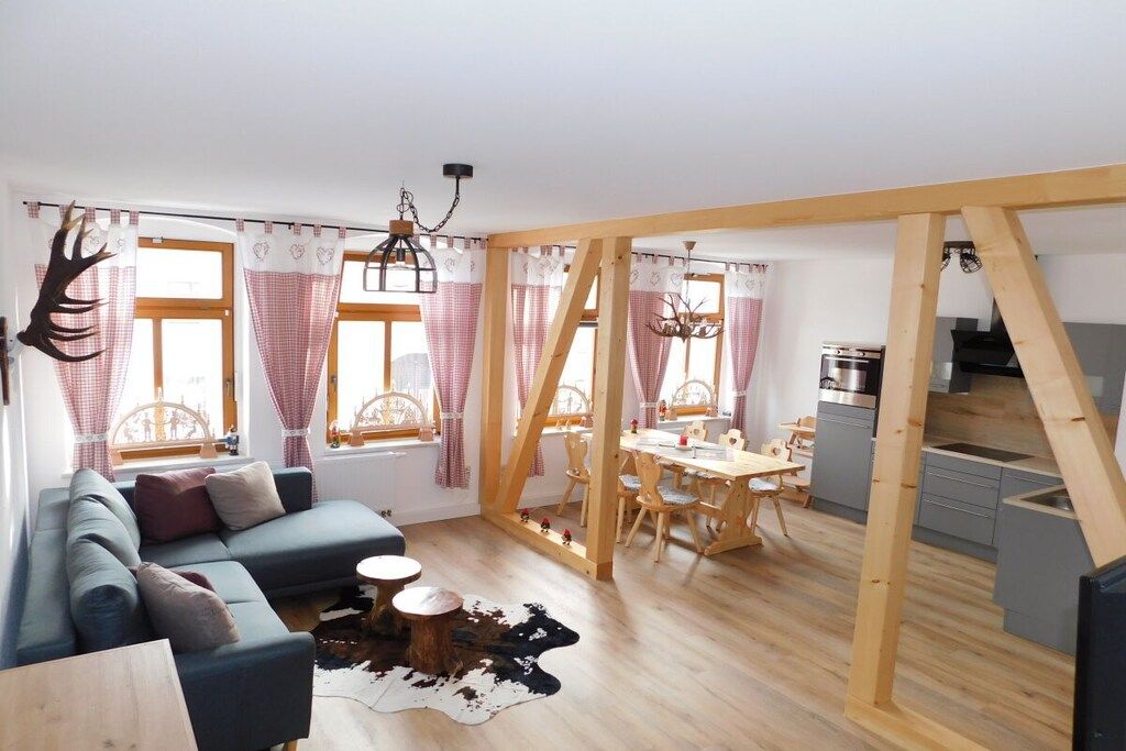 A modern interior with a dining area, kitchen, and living space.