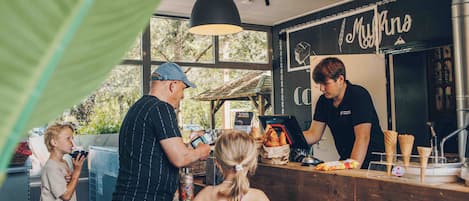 A food truck with a menu board and a counter.
