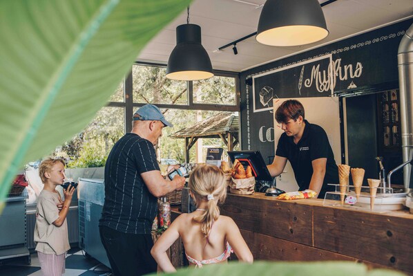 A food truck with a menu board and a counter.