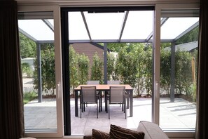 A modern room with a sliding glass door leading to an outdoor patio.