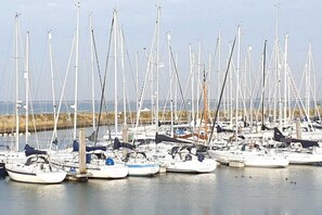 A marina with numerous sailboats docked. - Holiday paradise sea air (Kamperland)