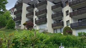A multi-story residential building with balconies, surrounded by greenery. - Apartment 'Harz 21' with Dreamy Balcony Views (Braunlage)