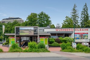 A building with a sign reading 'WURMBERGSEILBAHN'. - Apartment 'Harz 21' with Dreamy Balcony Views (Braunlage)