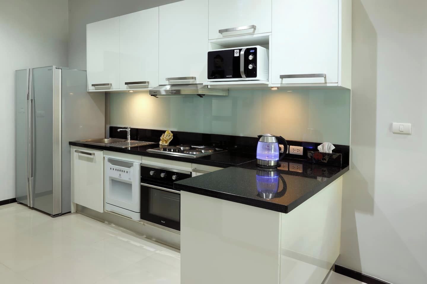 A modern kitchen with a built-in microwave, stove, and dishwasher.