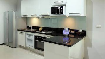A modern kitchen with a built-in microwave, stove, and dishwasher.