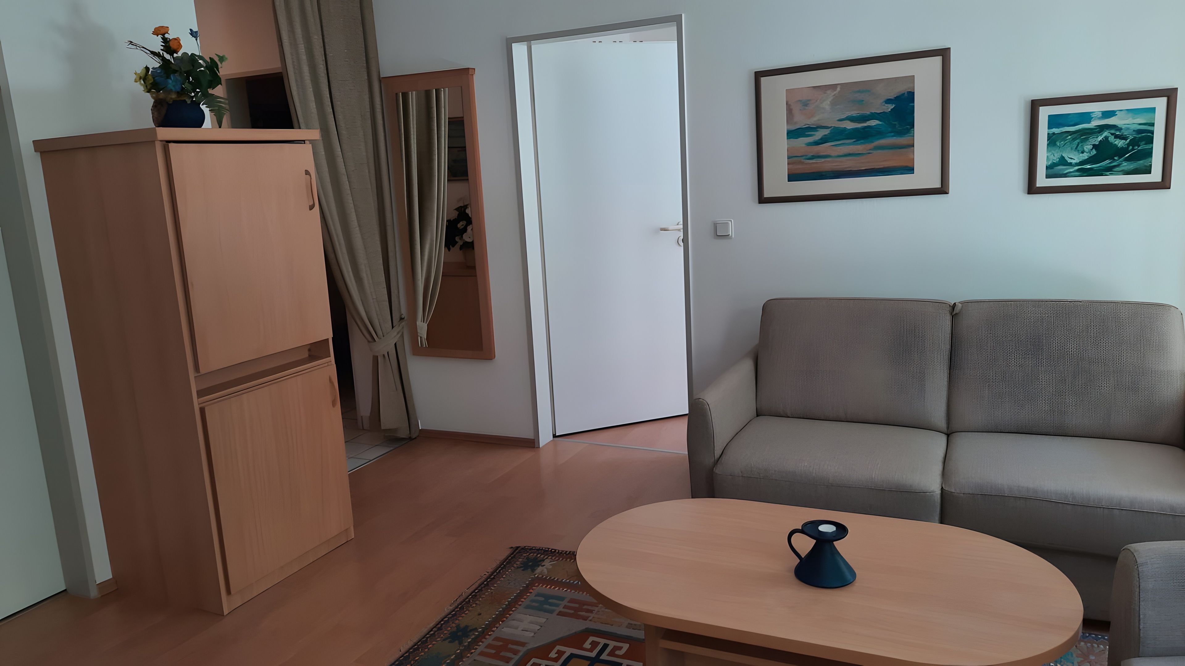 Ein Wohnzimmer mit einer Couch, einem Couchtisch und einem Schrank.