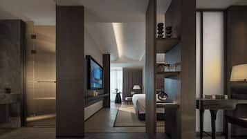A modern hotel room with a large bed, a desk, a television, and a seating area with a lamp.
