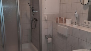 Ein modernes Badezimmer mit Dusche, Toilette und Waschbecken.