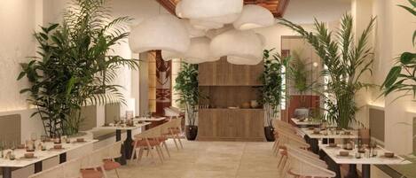 A restaurant with a long communal table, chairs, and potted plants.