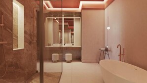 A modern bathroom with a freestanding bathtub, a glass-enclosed shower, and a large mirror.
