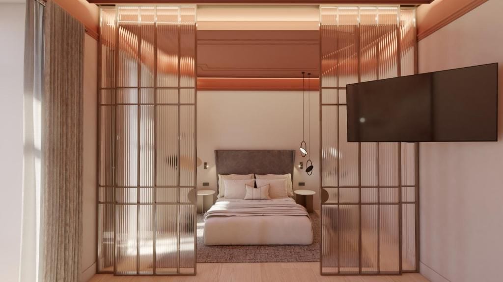 A bedroom with a bed, bedside tables, a TV, and a sliding door.