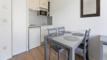 A compact kitchen with a microwave, stove, and dishwasher.