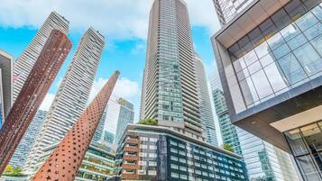 Un paysage urbain avec des immeubles modernes de grande hauteur, dont une structure remarquable aux lignes courbes et ornée de motifs en forme d’étoiles.