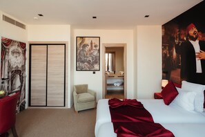A hotel room with a bed, a chair, a wardrobe, and a painting on the wall. - Art Hotel (Marrakech)