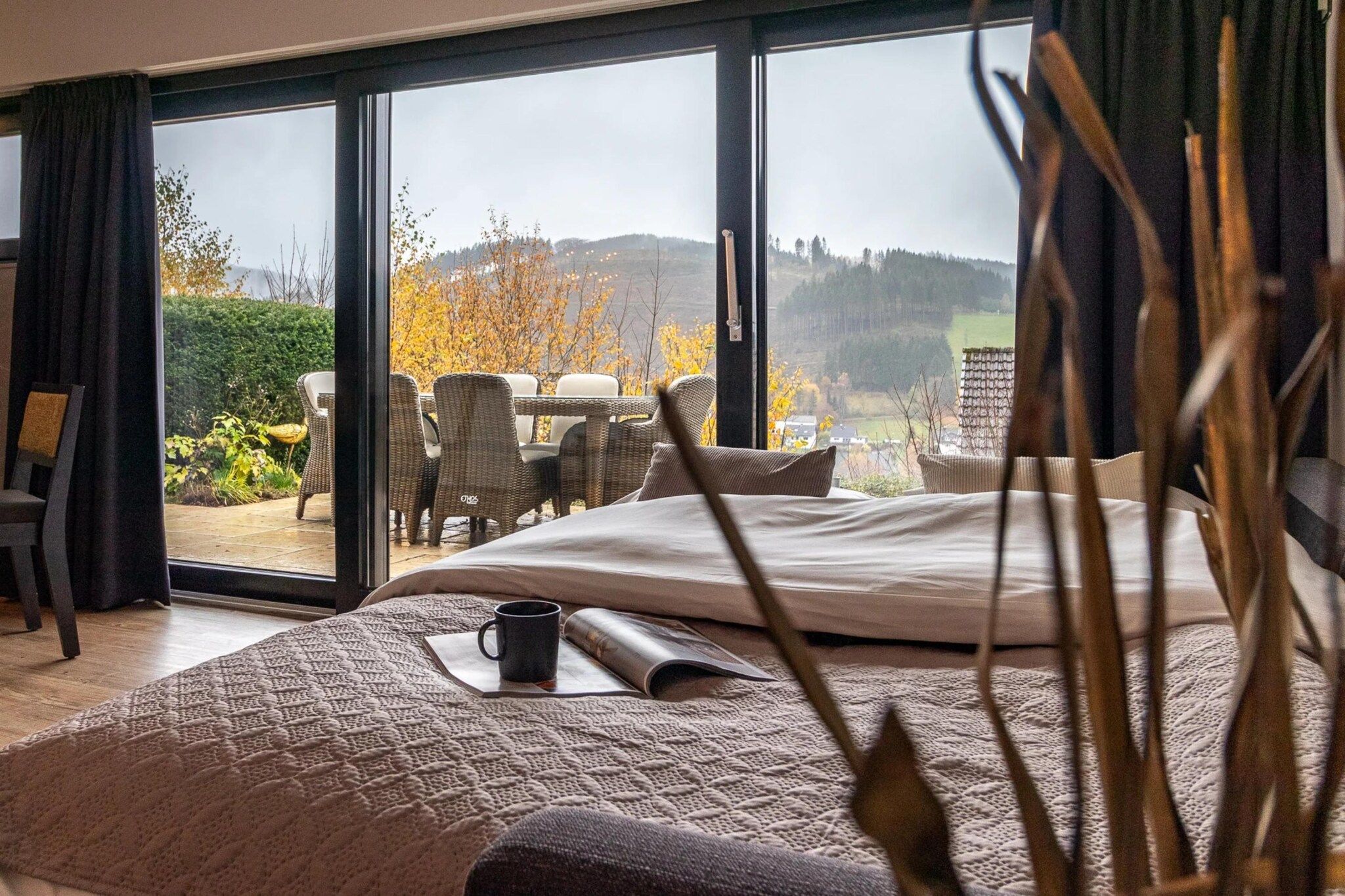 Une chambre avec un grand lit, une table basse et une vue sur l’extérieur.