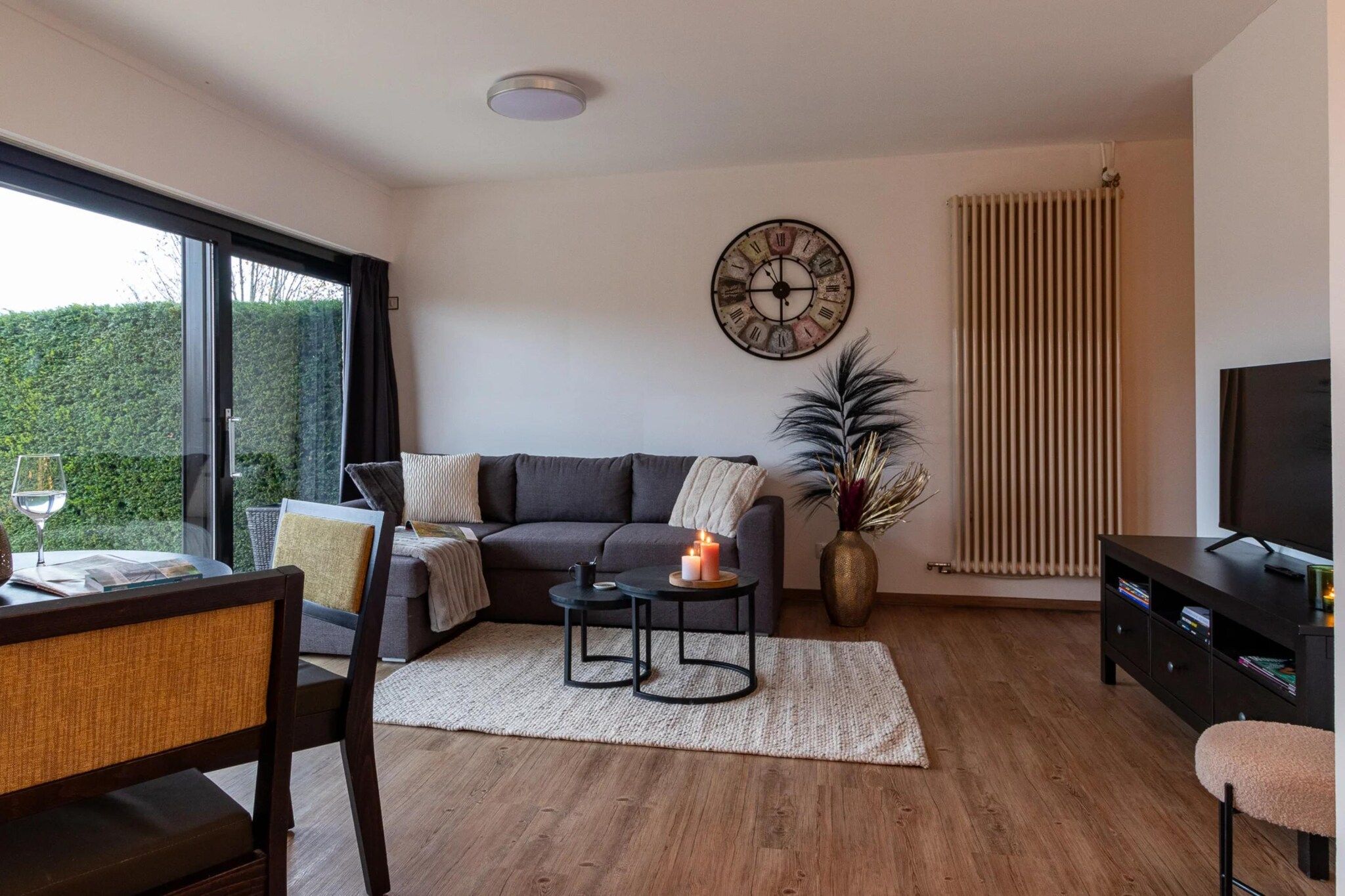A modern living room with a sofa, coffee table, and a TV.