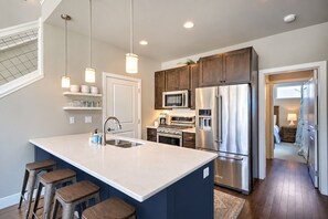 Door provides access to a pantry and laundry area with full size washer/dryer