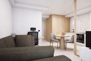 A modern living room with a sofa, a dining table with chairs, and a kitchen area with a stove.