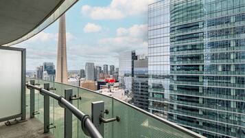 A high-rise building with a glass facade overlooking a cityscape.