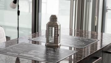 A table with a decorative lantern and a menu with coffee and espresso options.