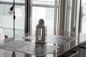 A table with a decorative lantern and a menu with coffee and espresso options. - Modern 2BR 1.5BA + Free Parking, CN Tower, Jays! (Toronto)