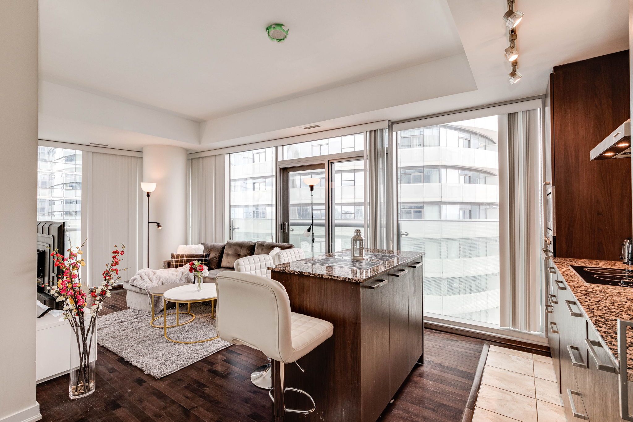 A modern apartment with a living area, a dining space, and a kitchen.