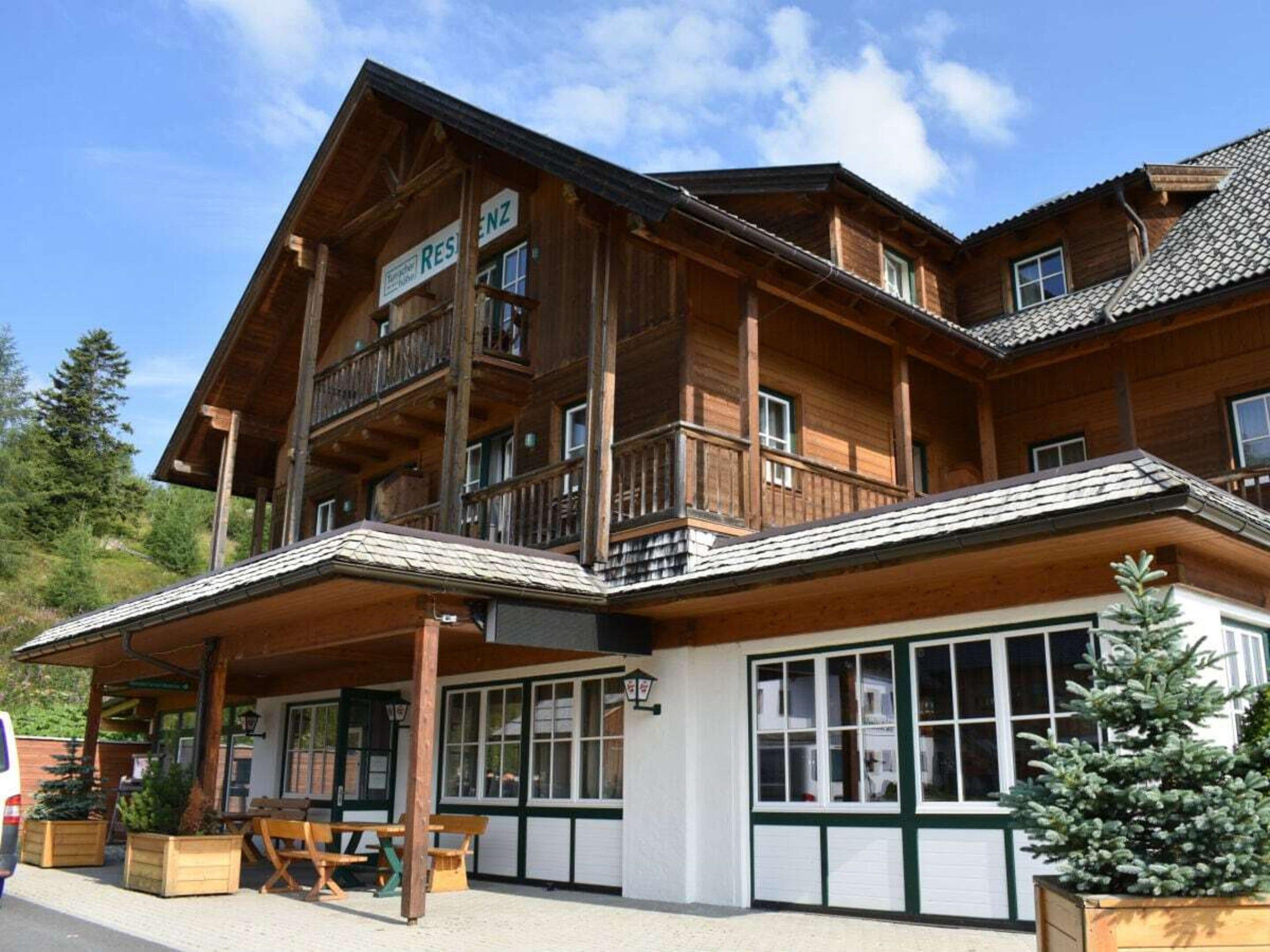 A wooden building with a sign reading 'RESTAURANT' and a balcony.