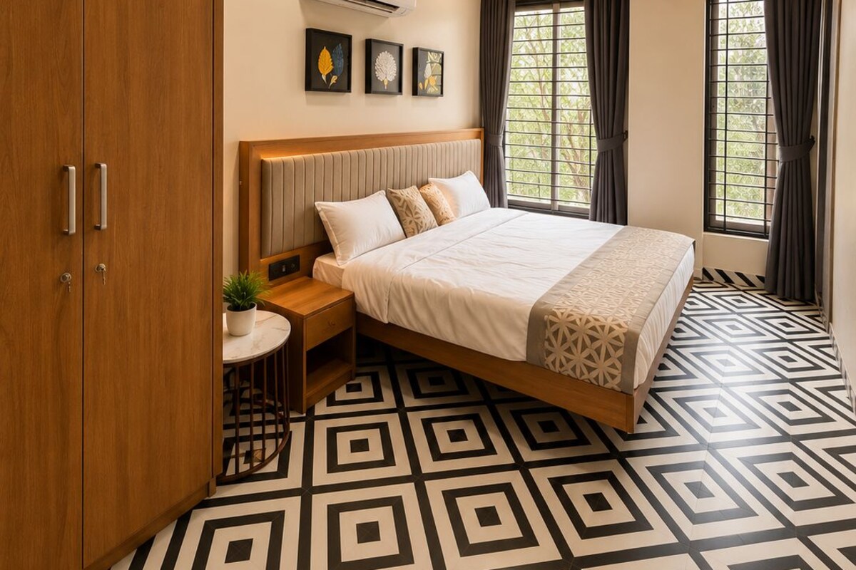 A modern bedroom with a bed, bedside table, and wardrobe.