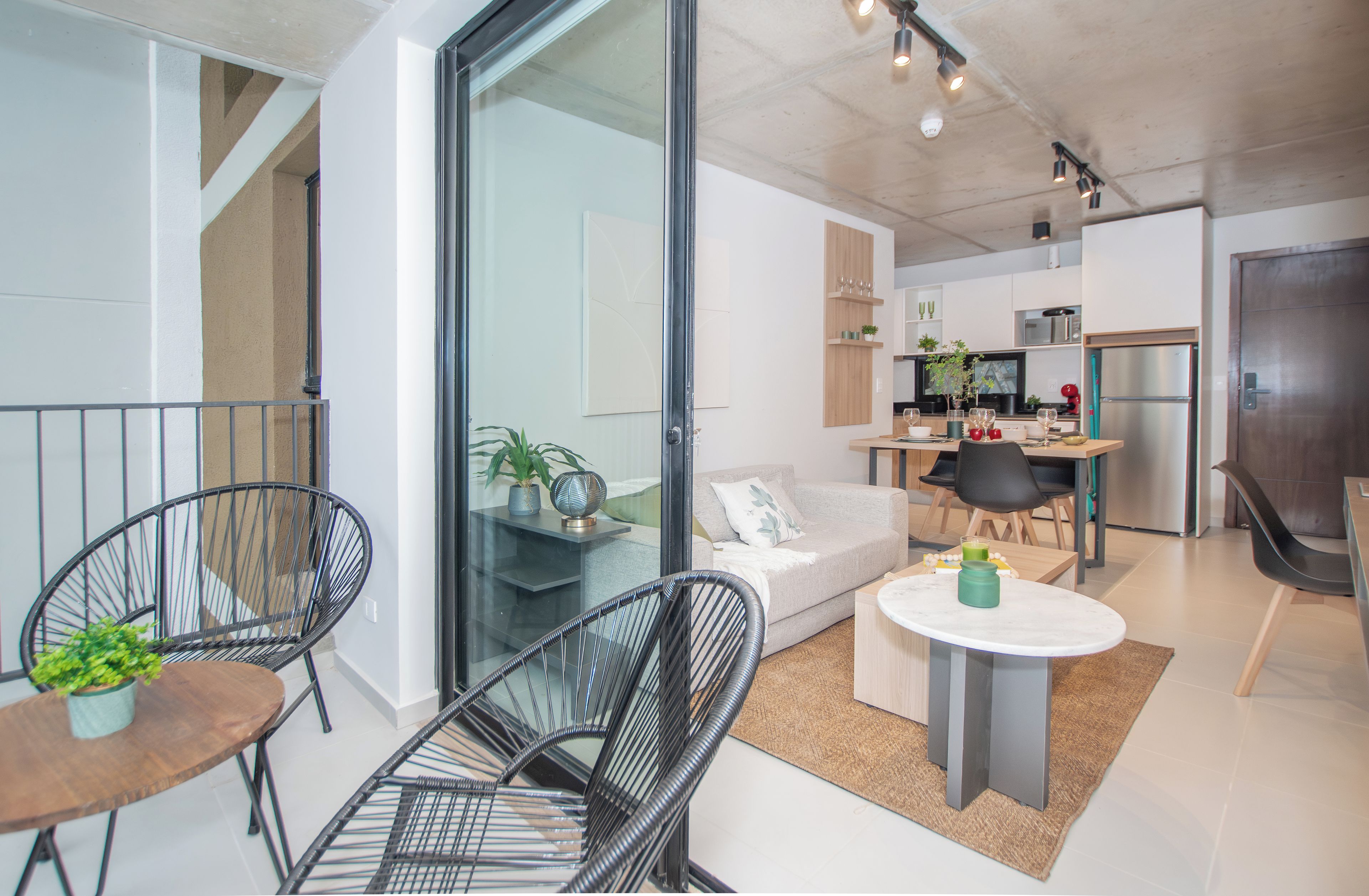 A modern apartment with a living area, kitchen, and dining space.