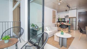 A modern apartment with a living area, kitchen, and dining space.
