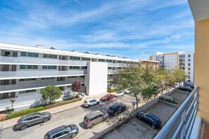 Un parking à plusieurs étages, situé à côté d’un bâtiment moderne doté d’un toit plat et de grandes fenêtres.