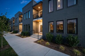 A modern multi-story residential building with a flat roof, large windows, and a visible address sign. - Walk to Hattie B s - East Nashville Sleeps 12 (Nashville)