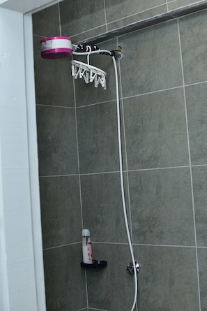 A shower with a handheld showerhead and a wall-mounted faucet. - The Sunset Nest - Serene 1-bedroom apartment perfect for relaxing stay (Kiambu Province)