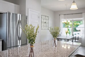 A kitchen with granite countertops, stainless steel appliances, and two potted plants. - 4Bedroom 3 Bath Athletes Retreat minutes near the Rome Tennis Center! Pool Hot Tub + Spa (Rome)