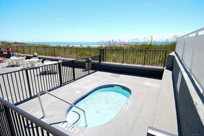 An outdoor swimming pool with a 1 1/2 ft depth, surrounded by a metal railing, with a view of the ocean in the background. - 3-bedroom, 2-bathroom, oceanfront condo, Plenty of updates and upgrades | Sea Castle - 3D (North Myrtle Beach)