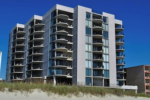 A modern multi-story hotel with balconies, large windows, and a flat roof. - 3-bedroom, 2-bathroom, oceanfront condo, Plenty of updates and upgrades | Sea Castle - 3D (North Myrtle Beach)