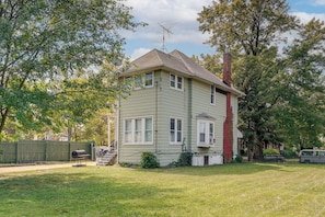 A two-story house with a visible chimney, a satellite dish, and a fenced yard. - 3 Mi to Belle Isle: Spacious Home w/ Yard (Detroit)