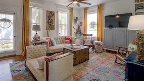 A living room with a sofa, armchair, coffee table, and a television. - Shop, Dine, Explore Dtwn! Walkable Farmington Home (Farmington)