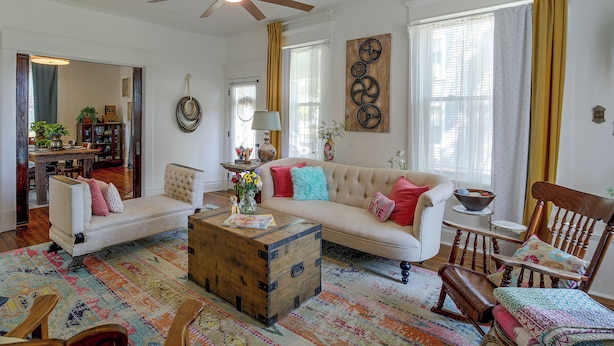 A well-lit living room with a ceiling fan, a sofa, a coffee table, and a patterned rug. - Shop, Dine, Explore Dtwn! Walkable Farmington Home (Farmington)
