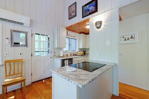 A kitchen with white cabinets, a wooden chair, a built-in stove, and a window. - Long-range Views in Gated Wolf Laurel/ski/ashville (Mars Hill)
