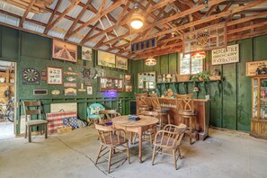 A rustic interior with a high ceiling, wooden beams, a round wooden table with chairs, and various maritime memorabilia. - 3 Bicycles & Peek-a-boo Lake Views! Barker Gem (Barker)