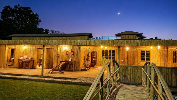 A wooden building with a covered outdoor area, a wooden bridge, and a staircase leading to the entrance. - The Ushmaya Wellness Resort Rishikesh (Rishikesh)
